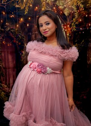 Pink tulle dress with floral details photographed in evening garden setting.