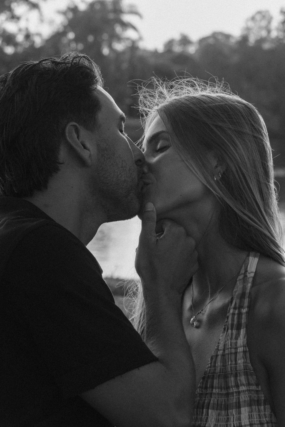 Monochrome couple photography featuring soft natural light and candid affection