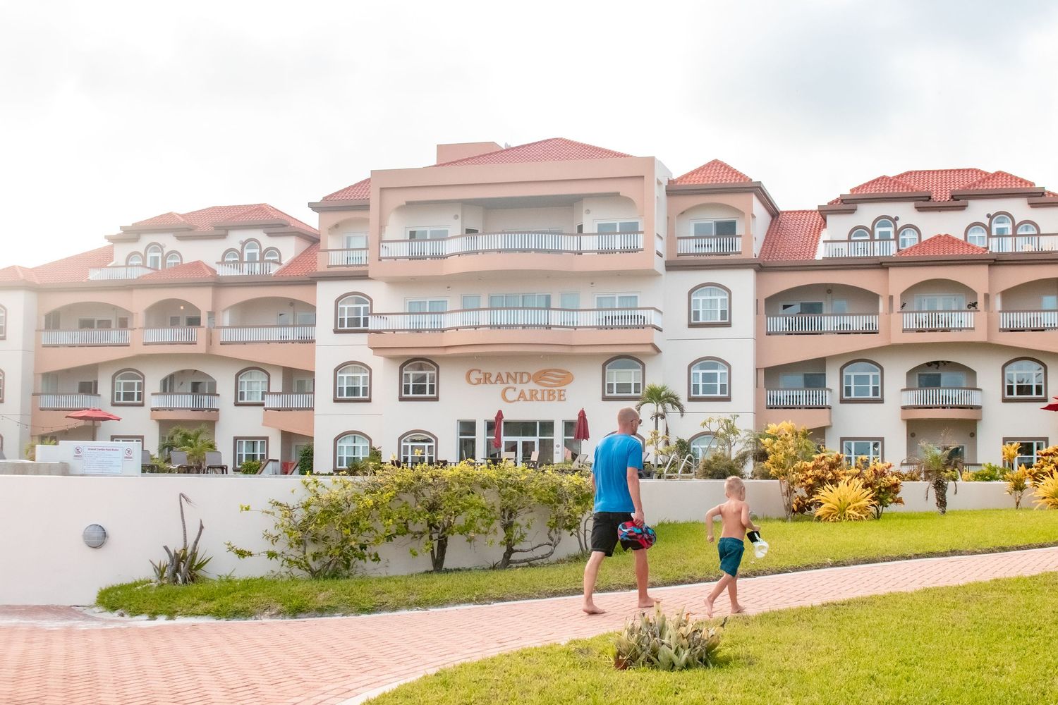 Panoramic view of luxury beachfront condominiums with Mediterranean-style architecture.