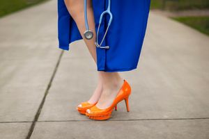 Boise State University graduate of nursing image of orange heals, blue gown, and stethoscope