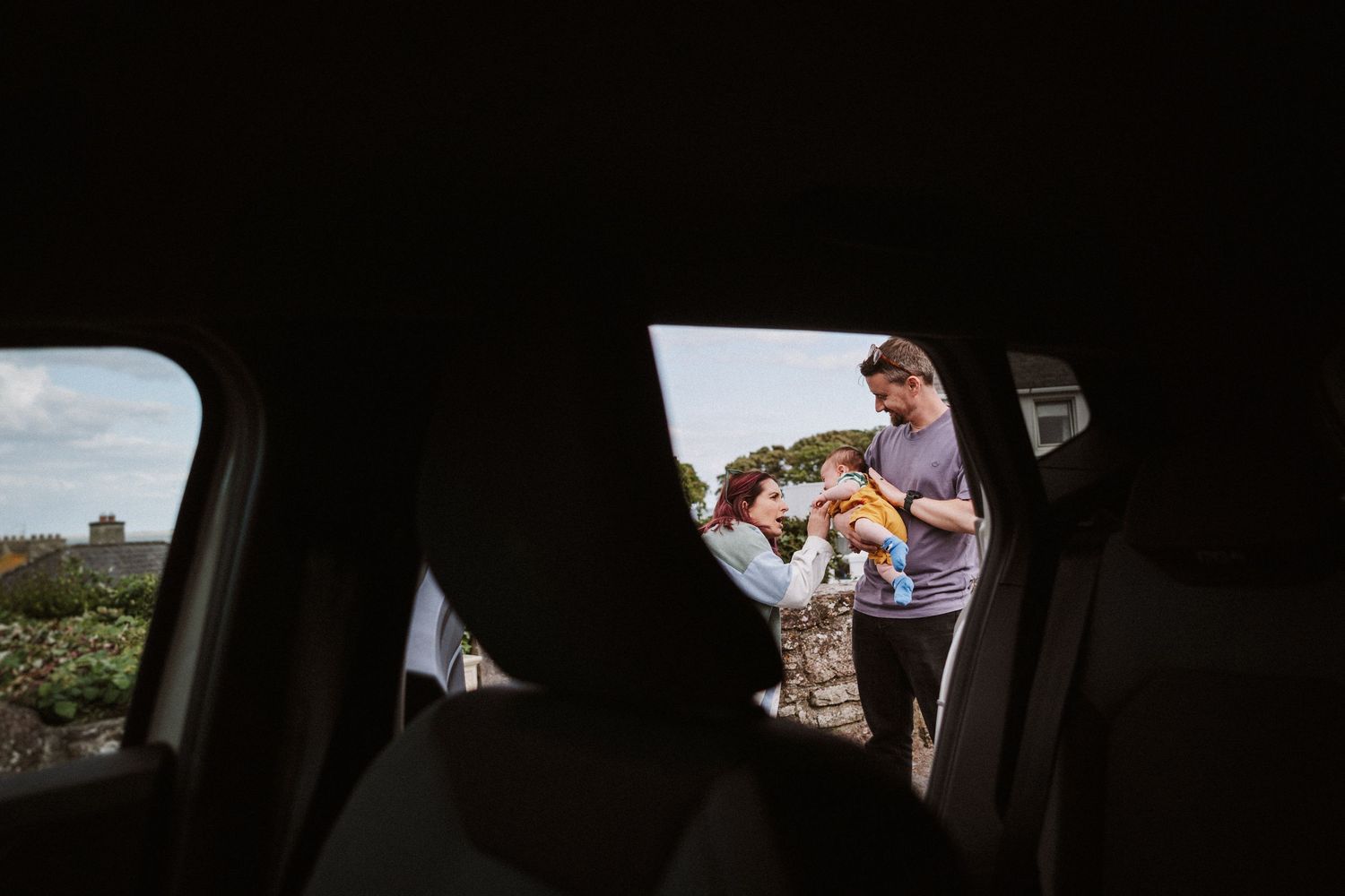 A series of dark interior car shots showing views through windows and mirrors with glimpses of scenery outside.