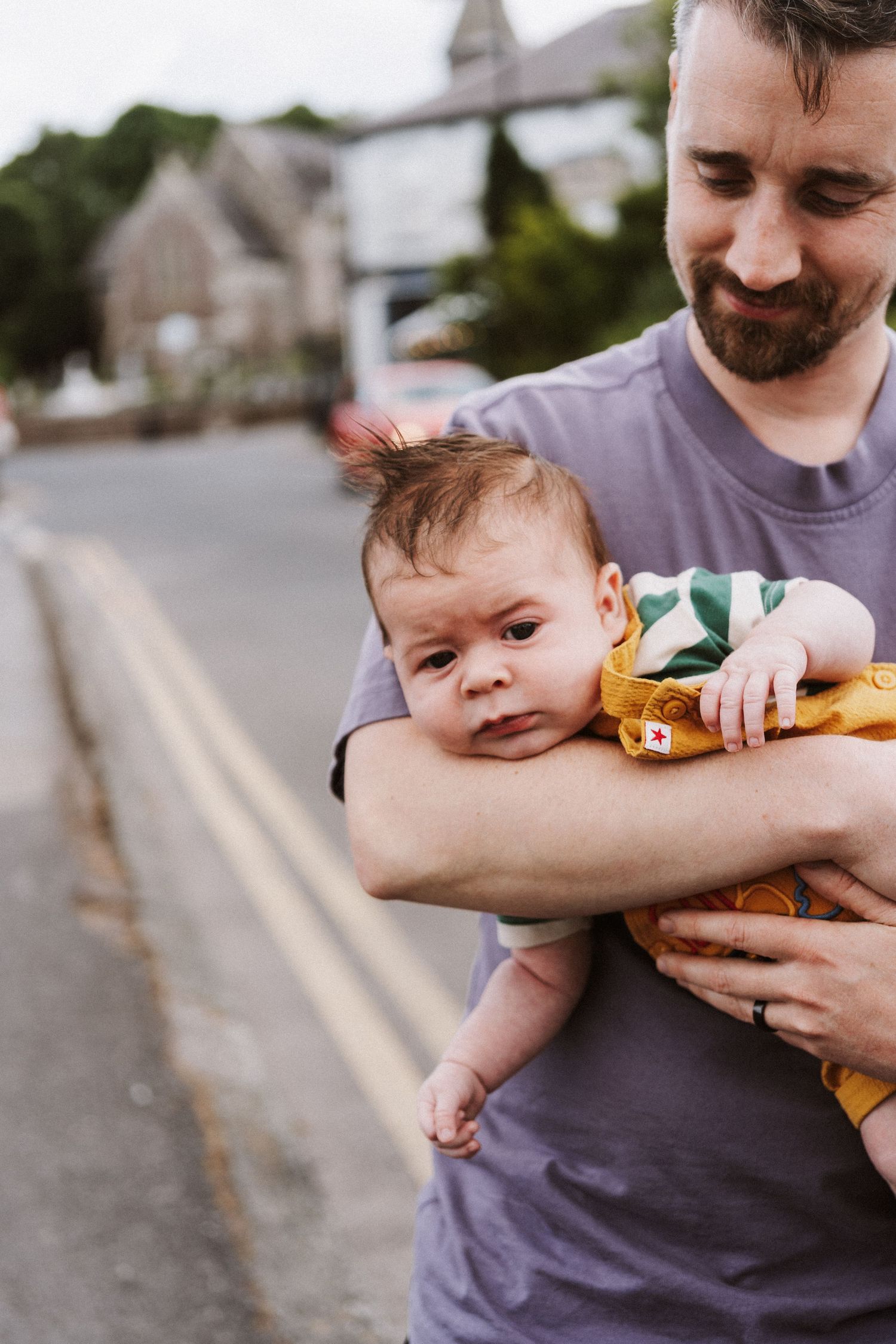 A parent in a gray shirt holds and plays with a baby wearing yellow outdoors in a series of candid moments.