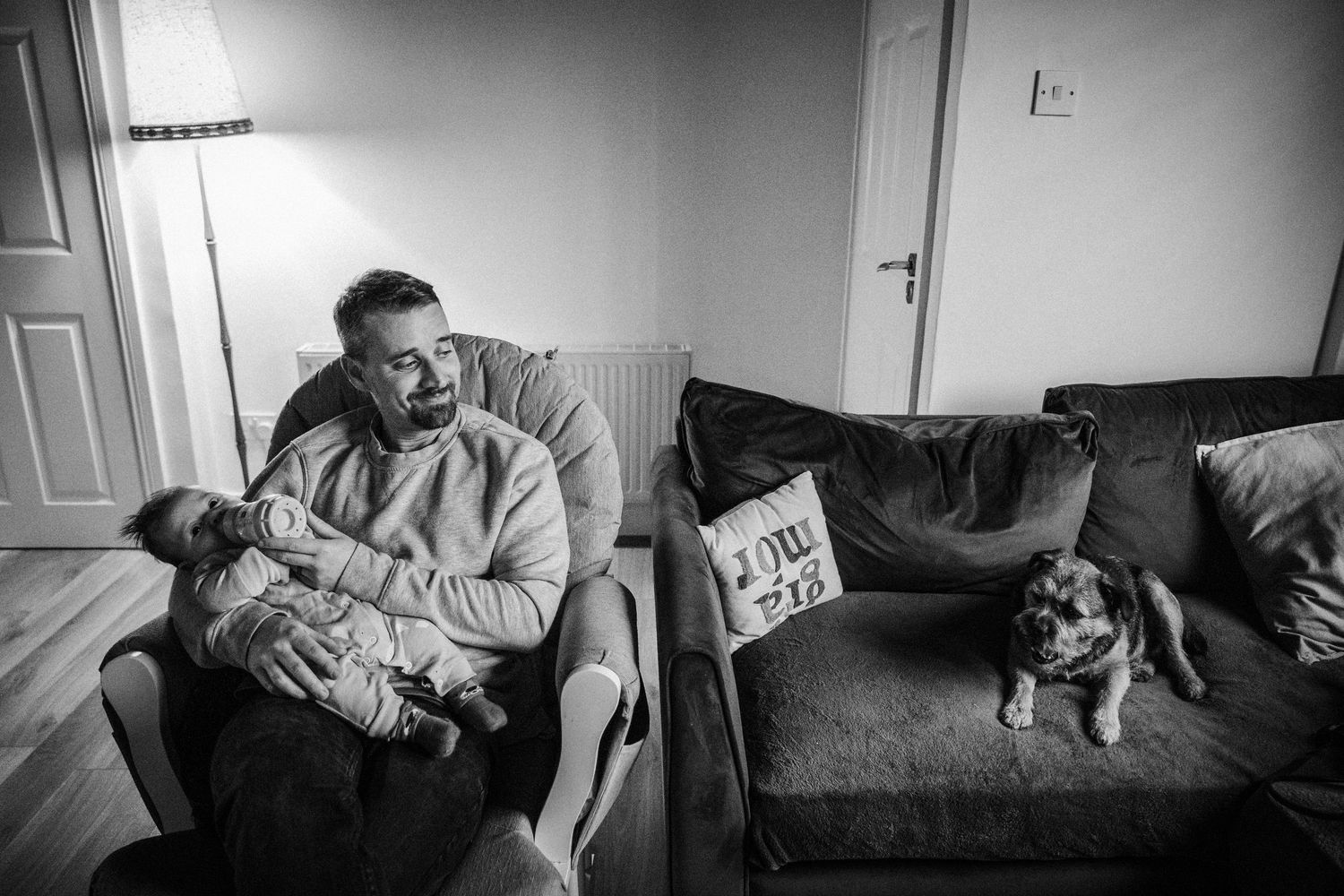 A black and white photo series showing intimate moments of a couple embracing and resting together on a couch.