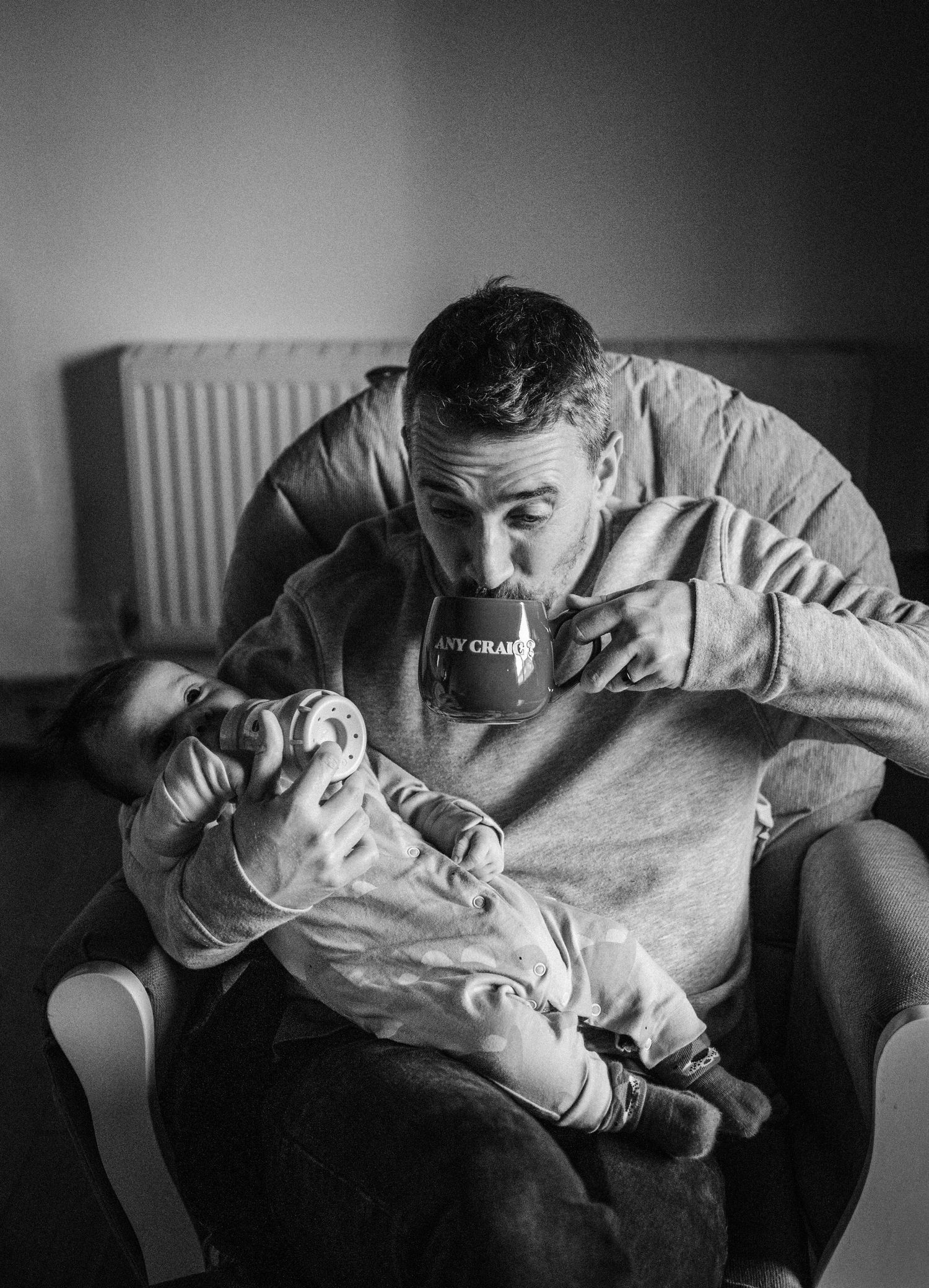 A series of black and white photos showing intimate moments between parent and baby in tender embrace.