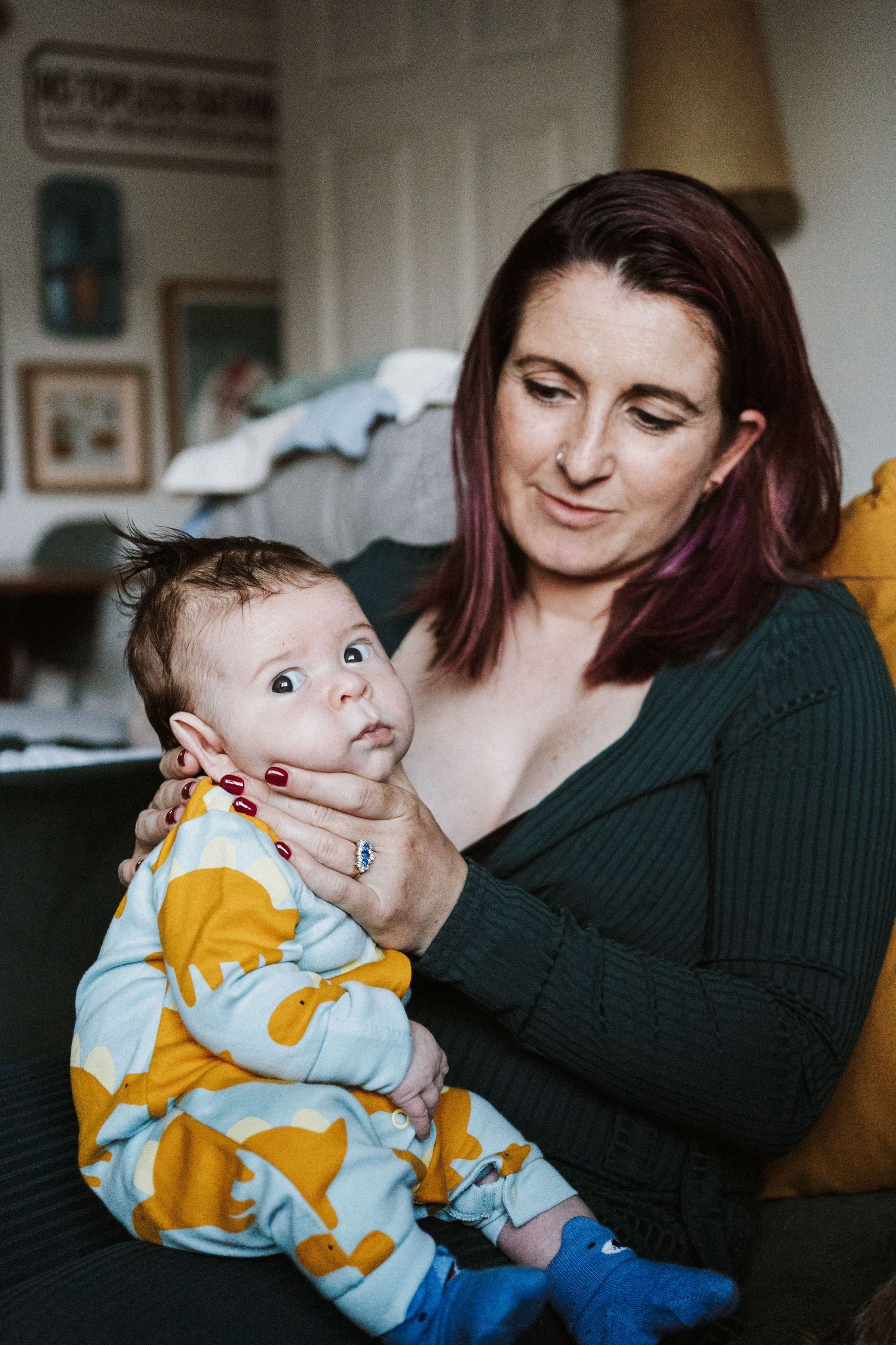 A baby wearing a yellow and blue outfit is being held while making playful expressions in a series of candid shots.