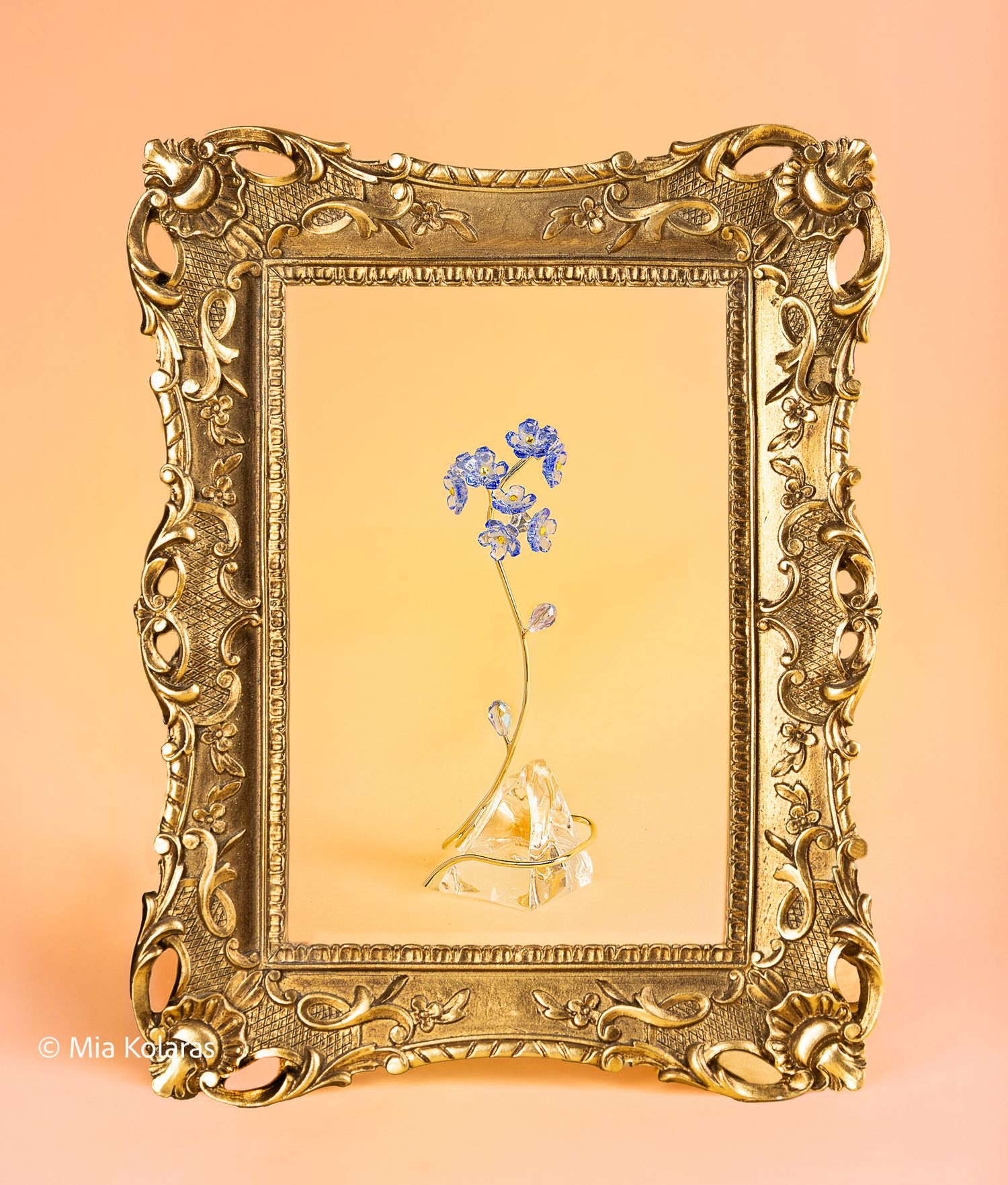 Swarovski Crystal Flower, Blue "Forget me Not", against a beige-pink backdrop, with a golden regency era-inspired frame
