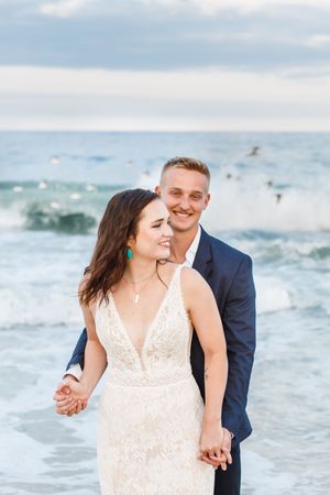 A couple shares intimate moments during their beach wedding photo session.