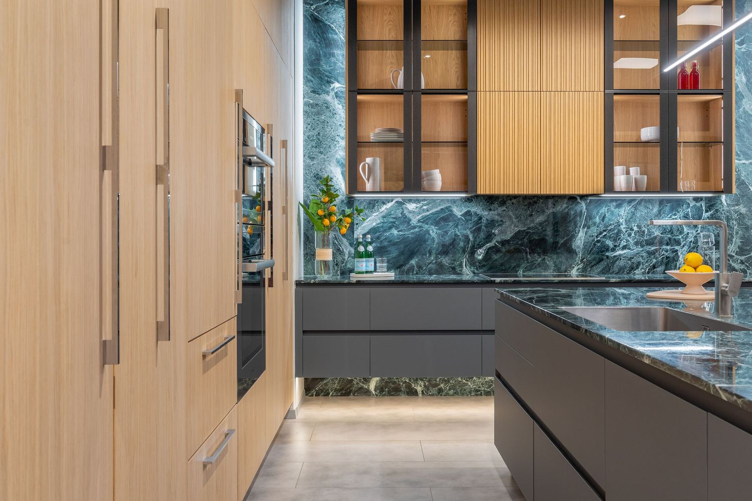 Luxurious kitchen featuring wood paneling and black marble countertops with modern appliances.