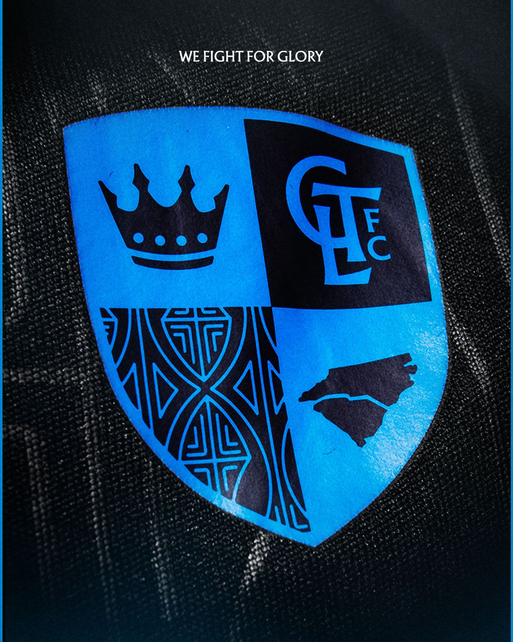 Charlotte FC shield crest with crown, CLFC initials, NC state outline, and tribal pattern on black kit.