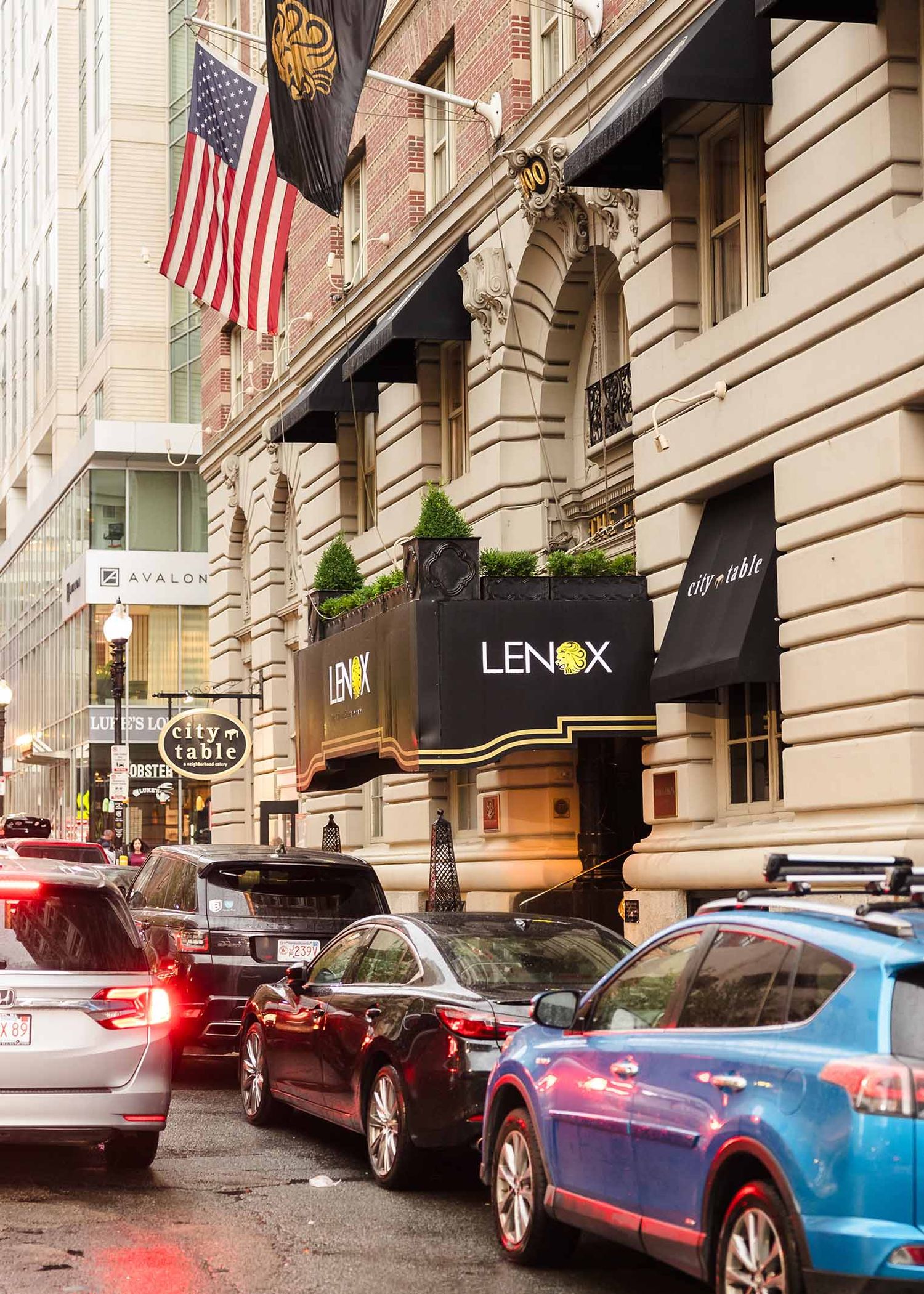 Entrance of Lenox Hotel Boston on Newbury Street with flags and classic architecture
