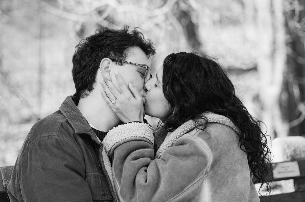 A series of black and white romantic photos showing tender moments between a couple in an outdoor setting.