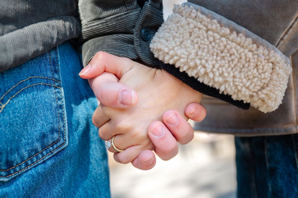 Close-up sequence showing hands holding and working with a small round clay pot or vessel.