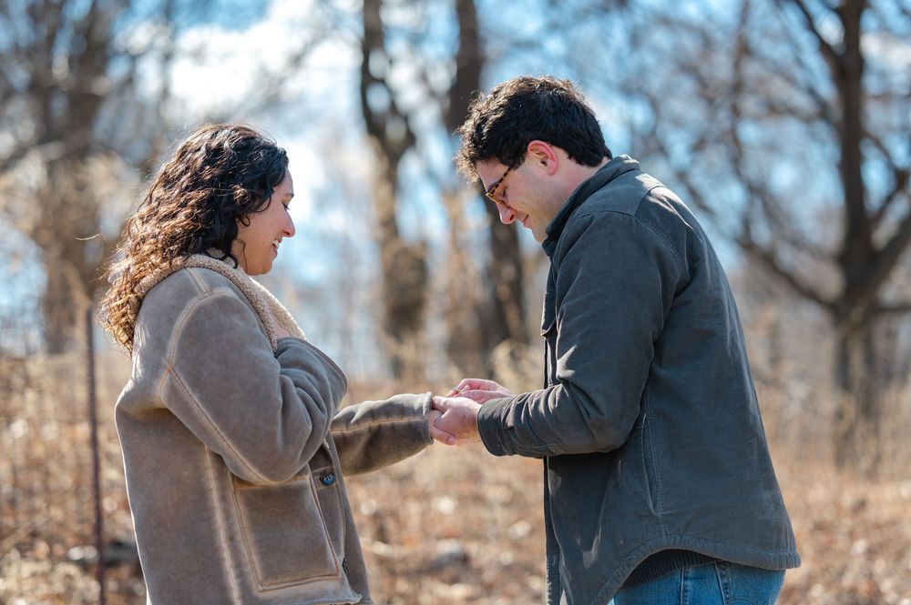 A couple shares a tender moment together outdoors during a winter engagement photoshoot in Brooklyn, NY.