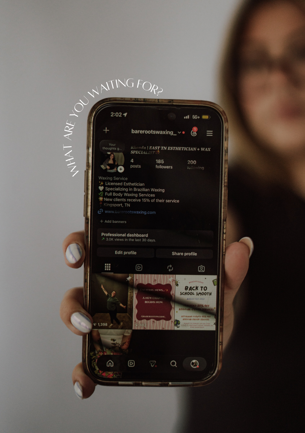 Woman holding smartphone displaying an Instagram business profile for a Brazilian waxing service with text overlay.