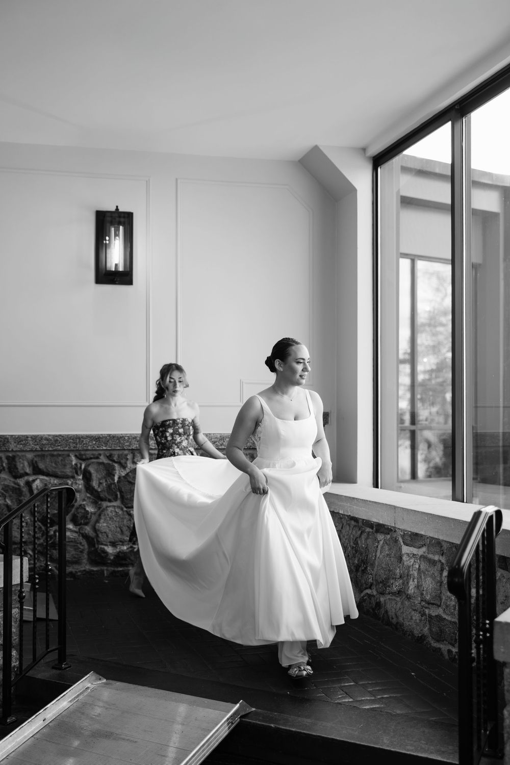 A sequence of artistic black and white photos showing a flowing white dress against a modern interior space.