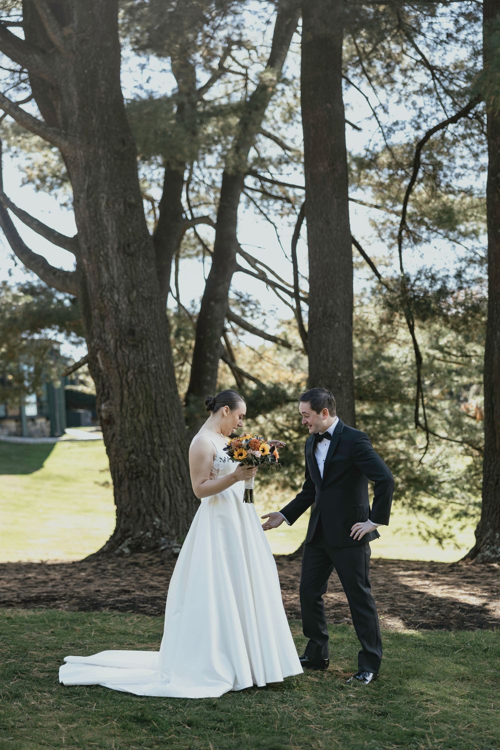 A romantic wedding photoshoot sequence under tall pine trees showing playful moments between the couple.