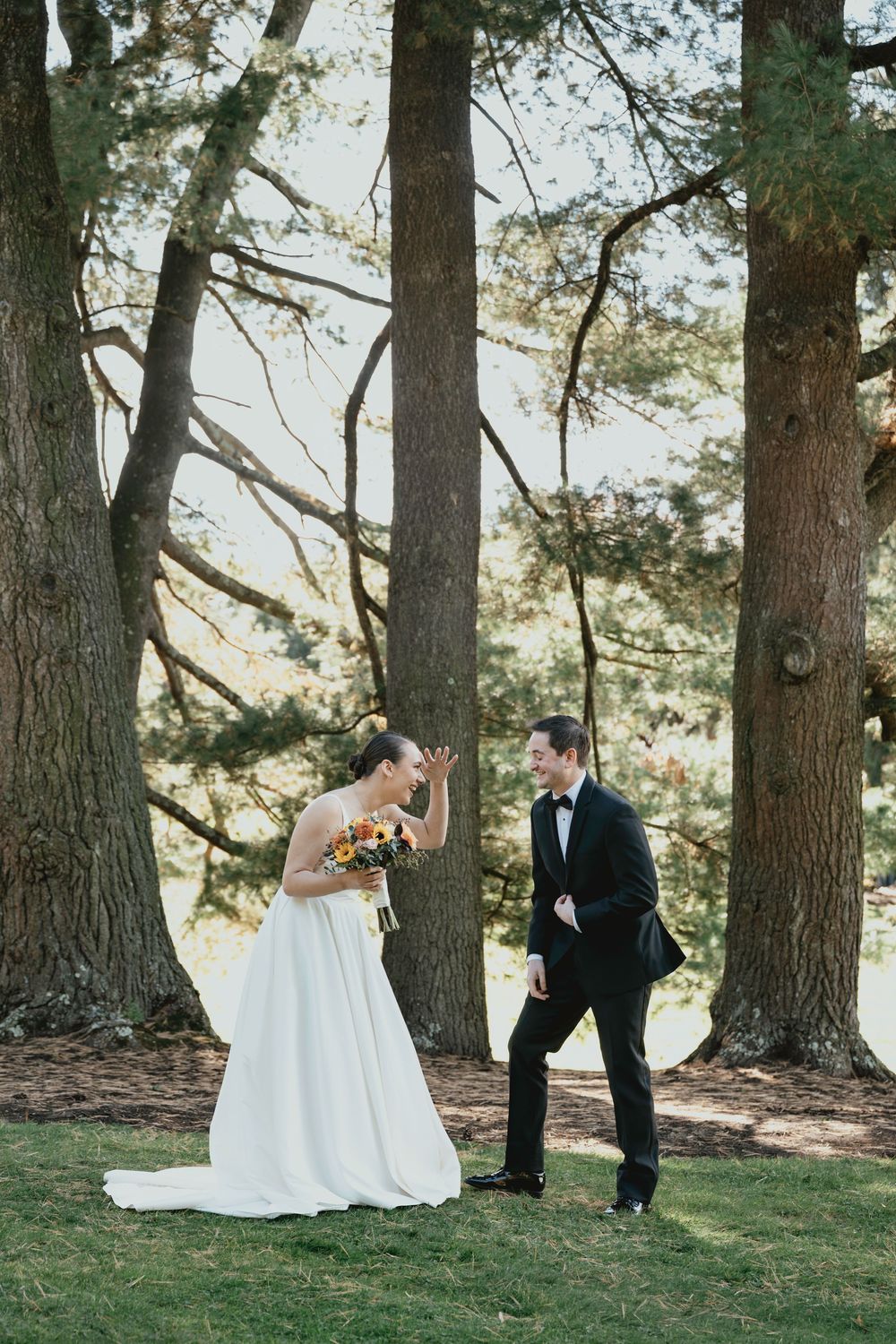 A playful wedding photo sequence showing interactions between the couple among tall pine trees.