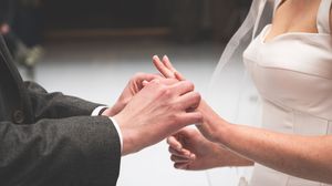 Hands in black and white showing various stages of a handshake in a business setting.
