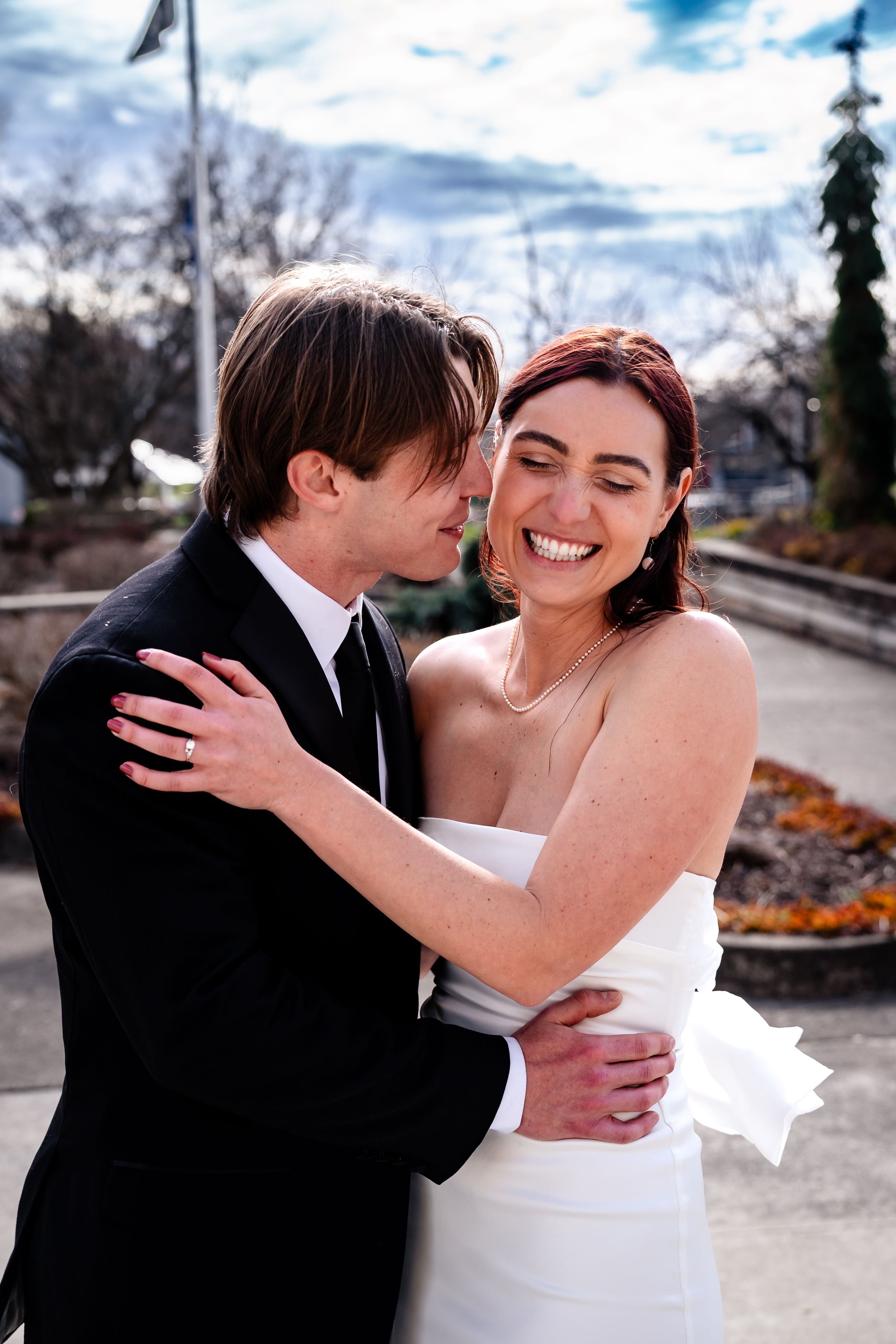 A couple shares romantic moments outside a historic building on their wedding day.