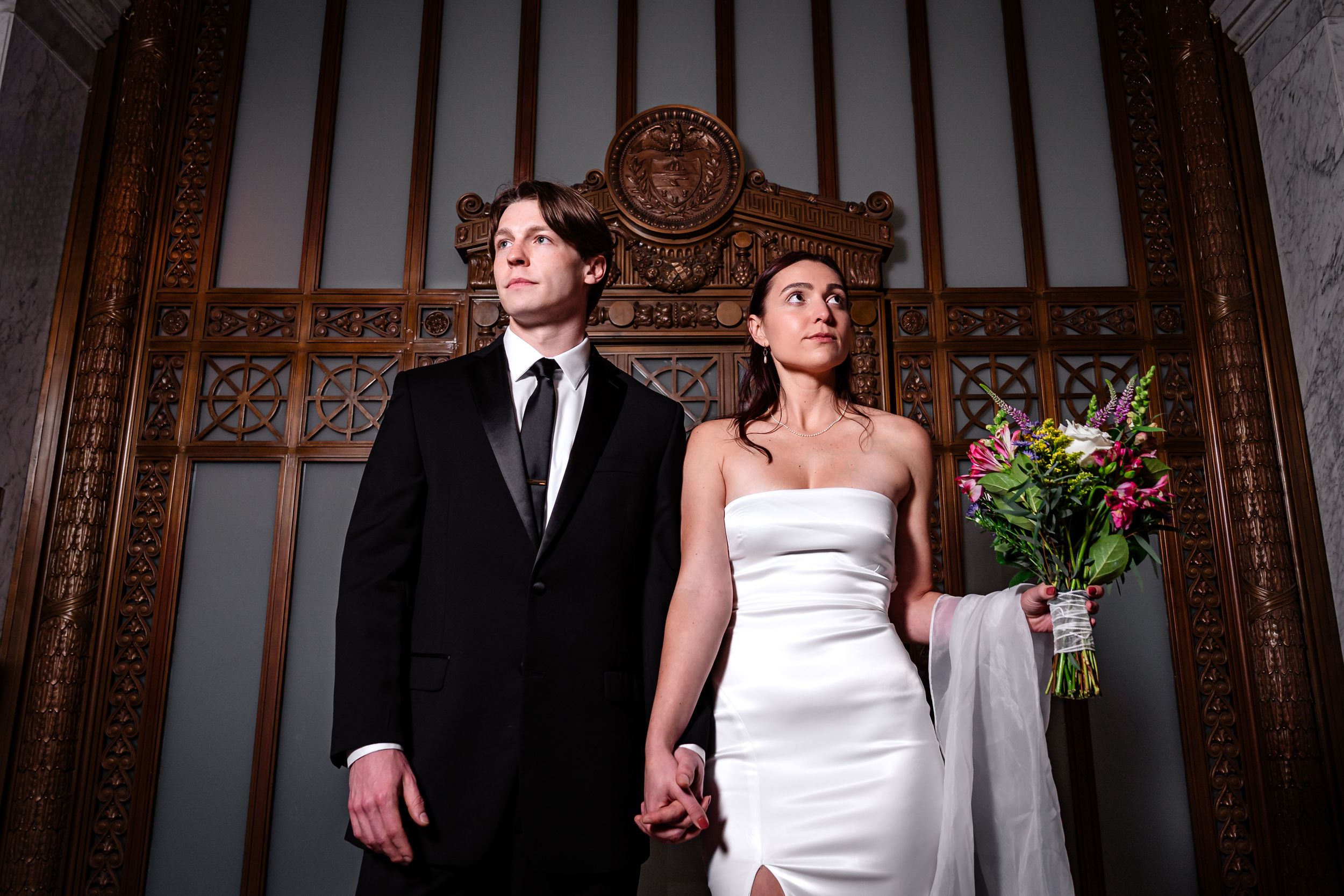 A series of five wedding photos showing a bride and groom posing in front of an ornate wooden backdrop.