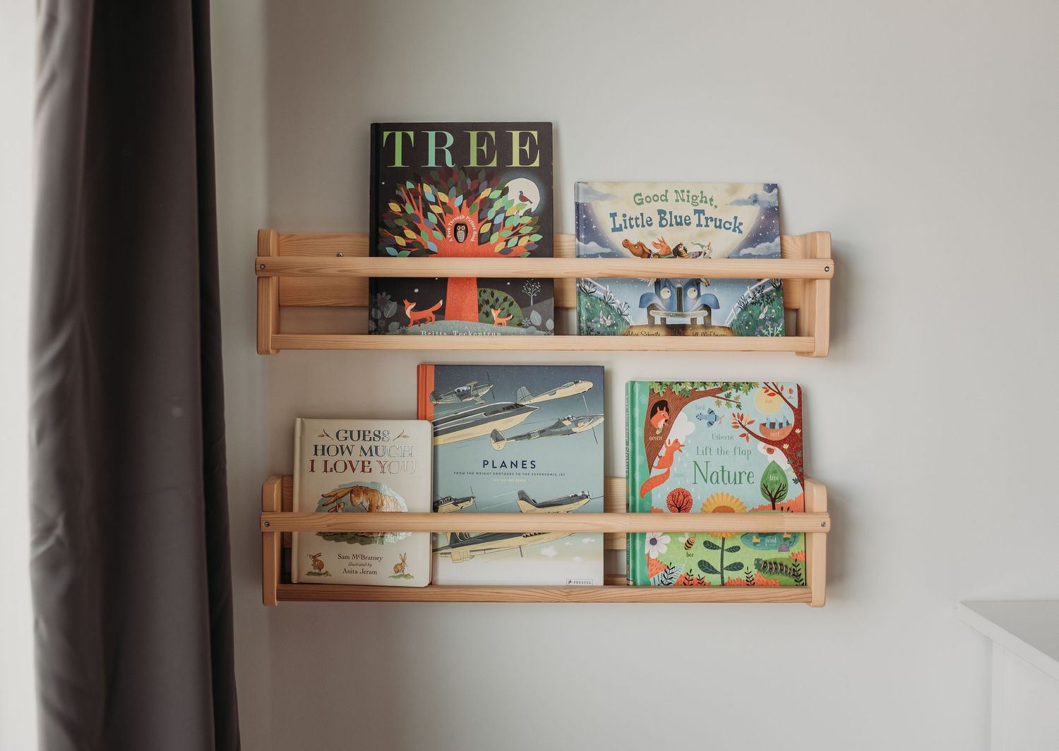 a few favorite books on the wall of a nursery