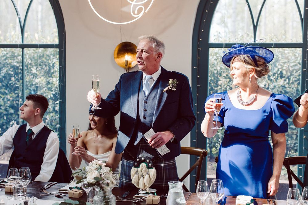 A series of wedding reception photos showing guests dining and celebrating at tables in an elegant venue with large windows.
