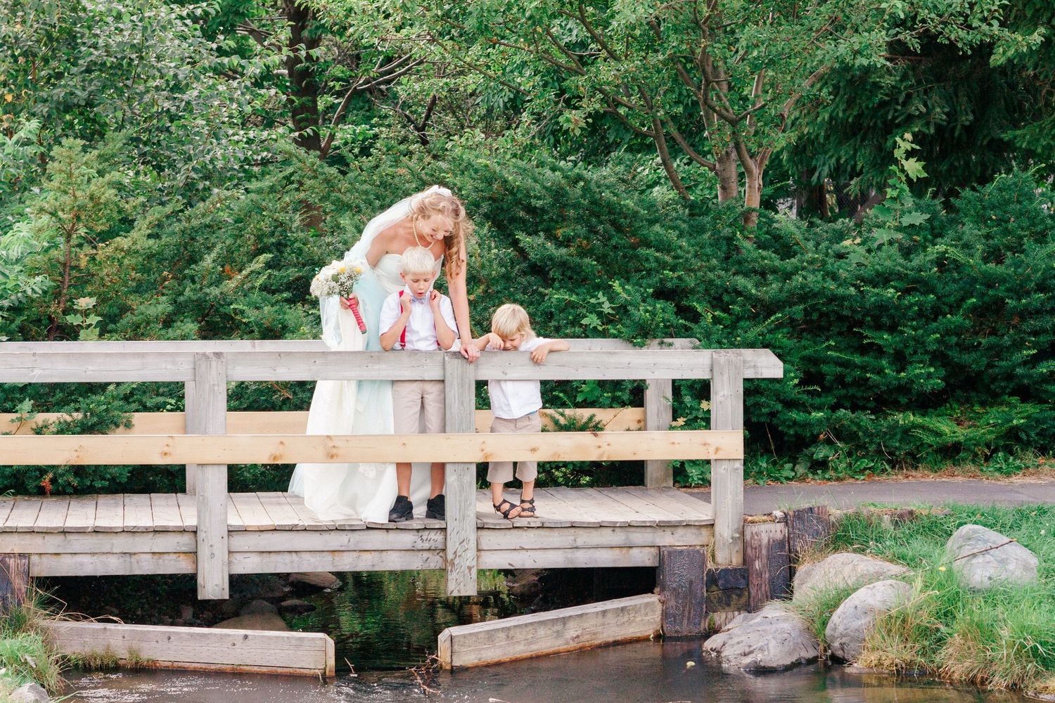A series of wooden boardwalk sections winding through lush green forest scenery.