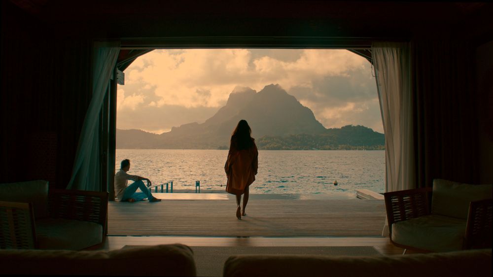 A panoramic sequence of oceanfront window views showing a beach landscape at different times of day with dramatic lighting.