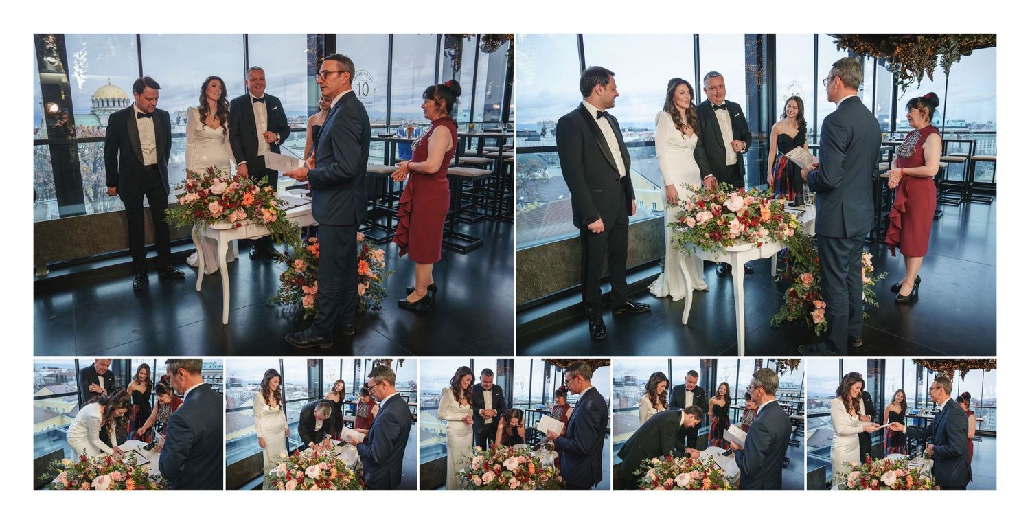 Group gathering in a modern venue with floor-to-ceiling windows overlooking a city skyline at sunset.