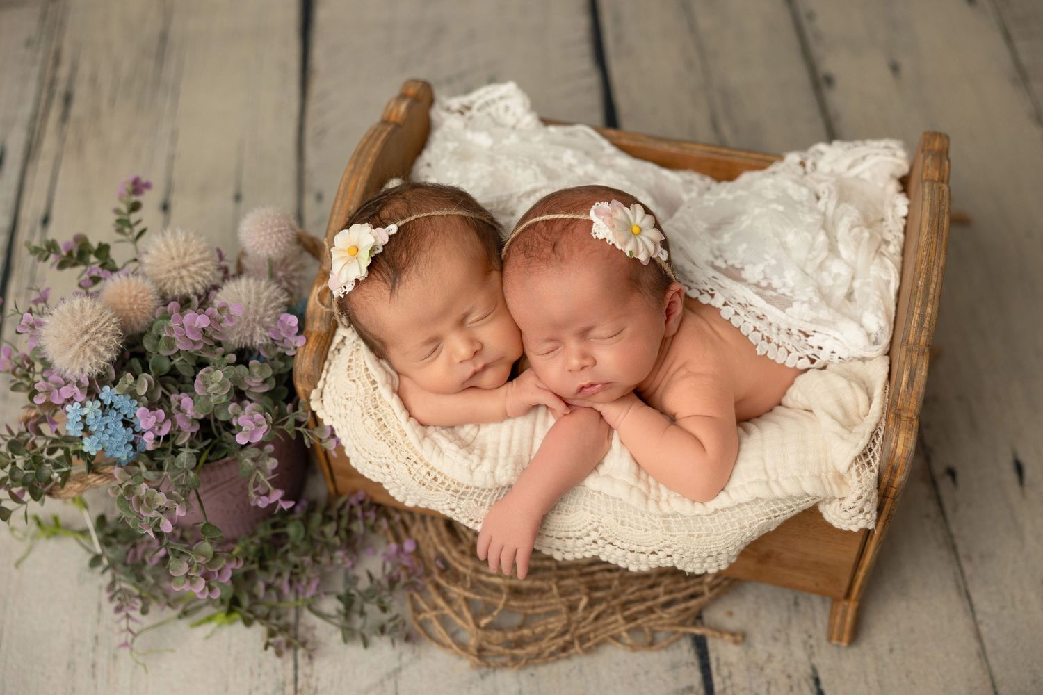 A collage of newborn baby photography showing sleeping infants in rustic baskets with delicate lace and floral accents.