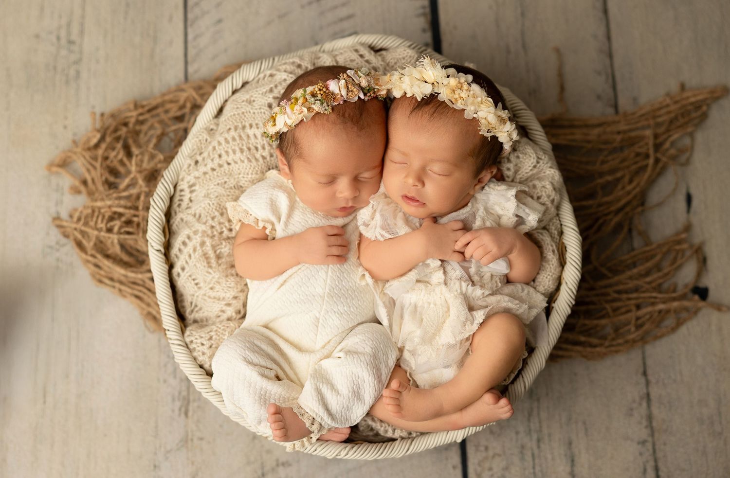 A panoramic series of newborn baby portraits arranged horizontally showing sleeping infants in woven baskets.