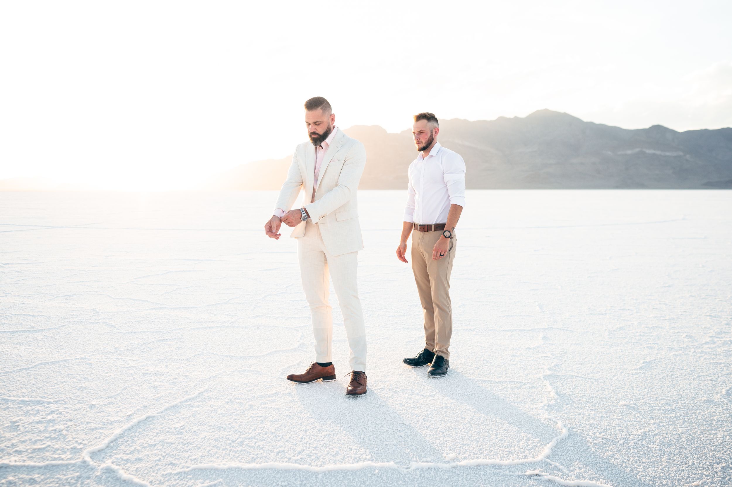 A small elopement on the salt flats with mountains in the distance at sunset. Salt flats elopement wedding photographer. Couples photography