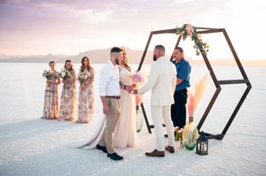 A small elopement on the salt flats with mountains in the distance at sunset. Salt flats elopement wedding photographer. Couples photography