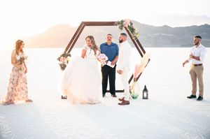A small elopement on the salt flats with mountains in the distance at sunset. Salt flats elopement wedding photographer. Couples photography