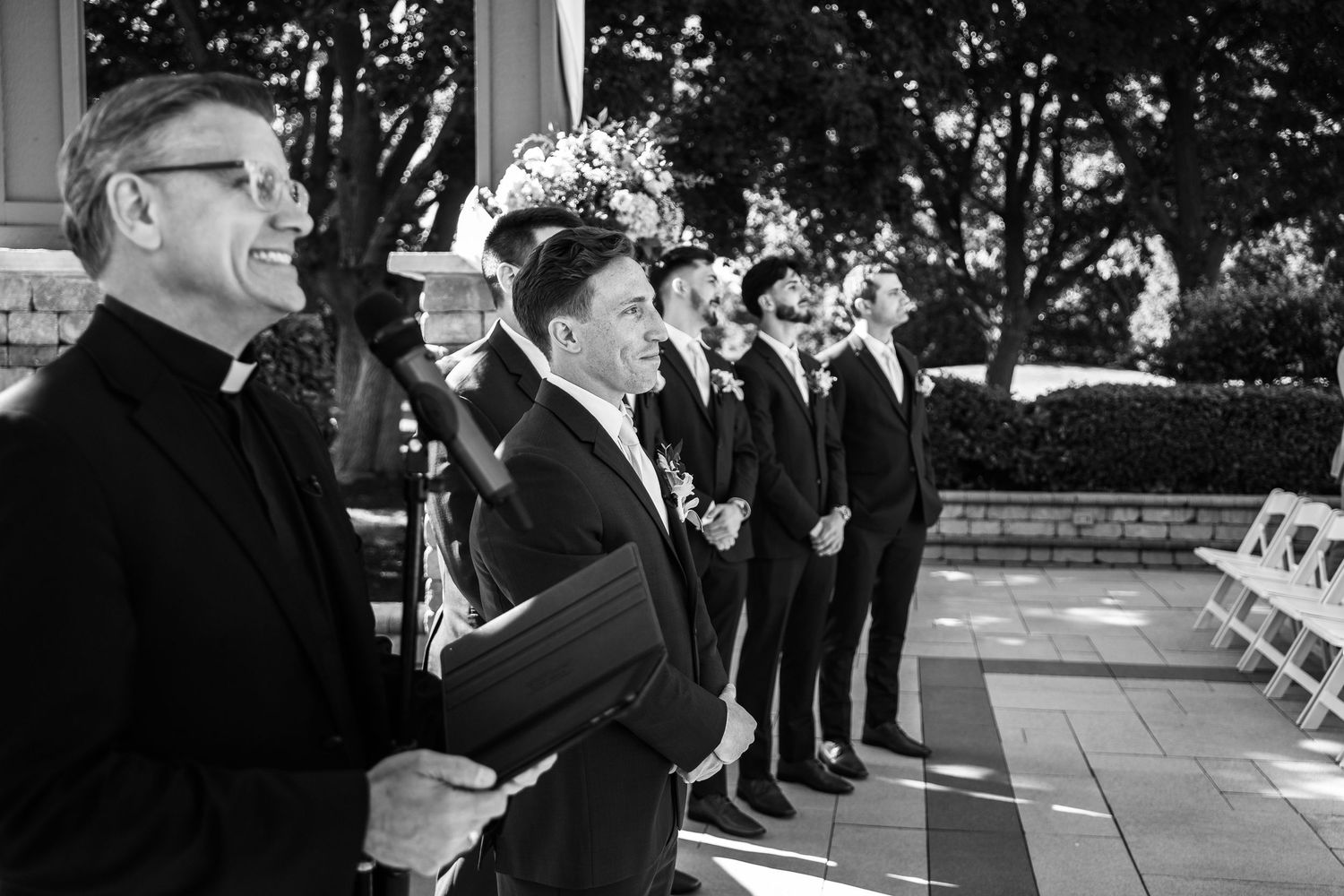 A black and white collage of candid moments at a formal event with people in suits and dresses mingling outdoors.