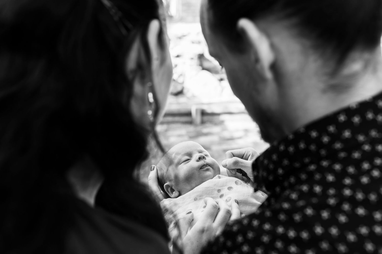 Calm newborn moment showing natural connection between parent and baby.