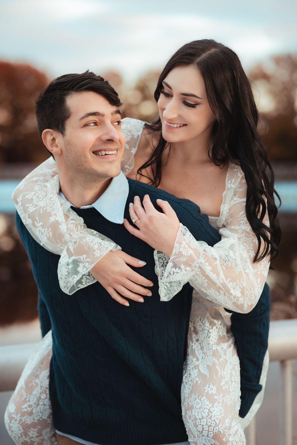 Close-up portrait of smiling couple embracing outdoors.