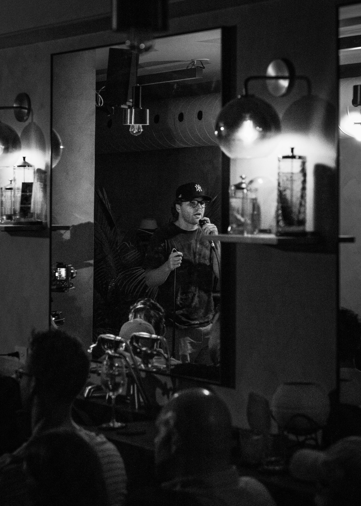 Event photography capturing live moments from the 'Mess Produced' comedy show with performers on stage