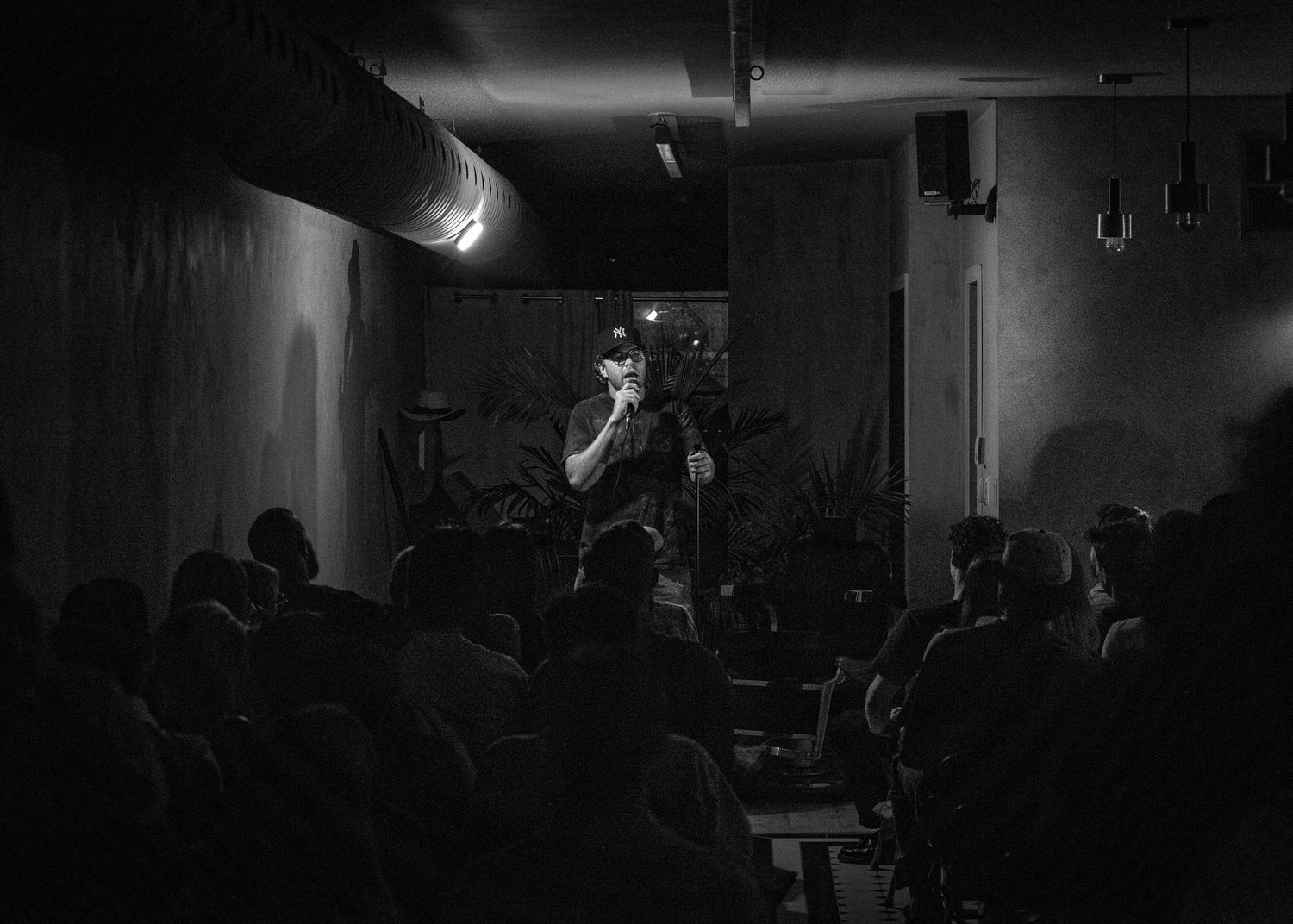 Event photography capturing live moments from the 'Mess Produced' comedy show with performers on stage