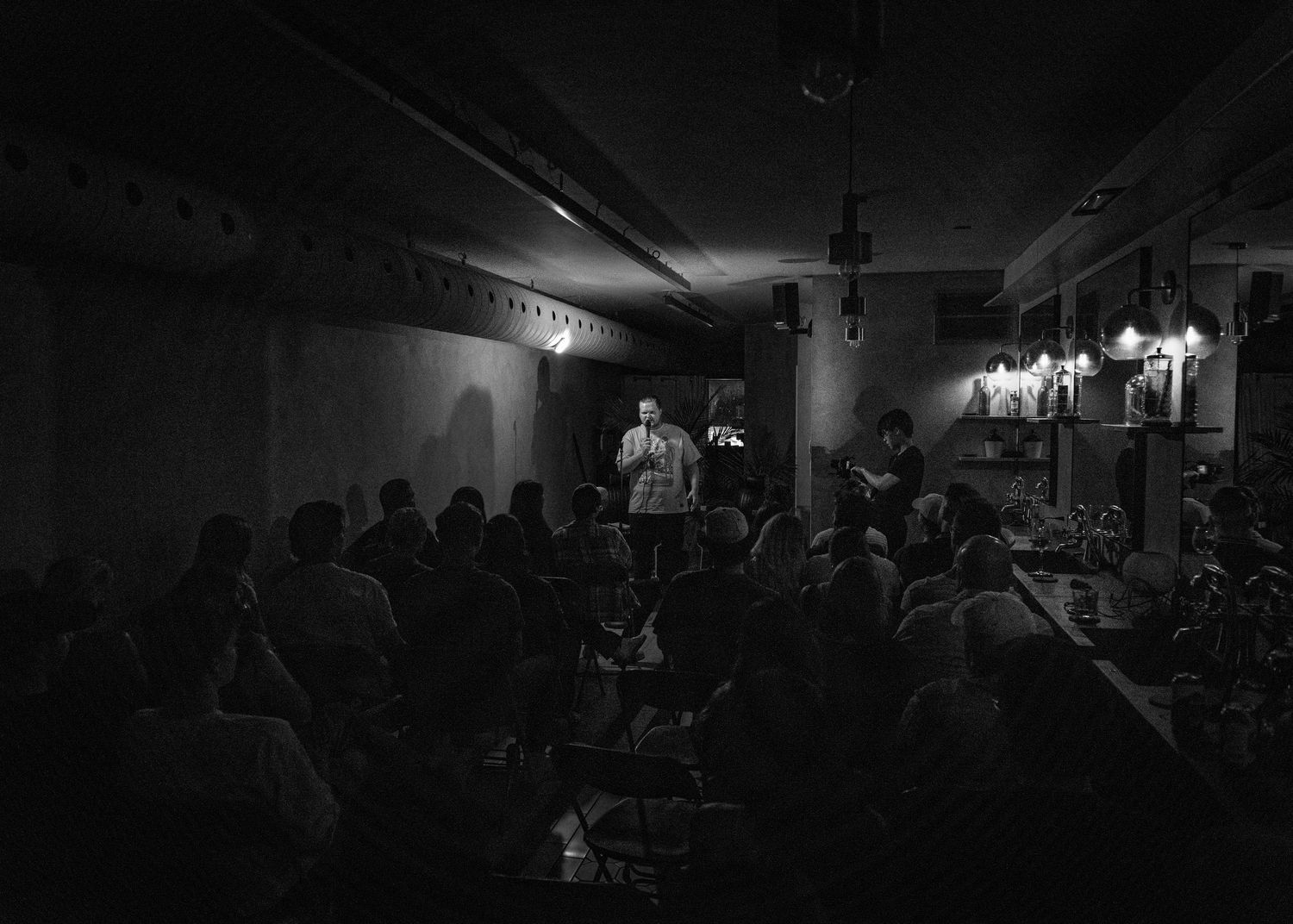 Event photography capturing live moments from the 'Mess Produced' comedy show with performers on stage