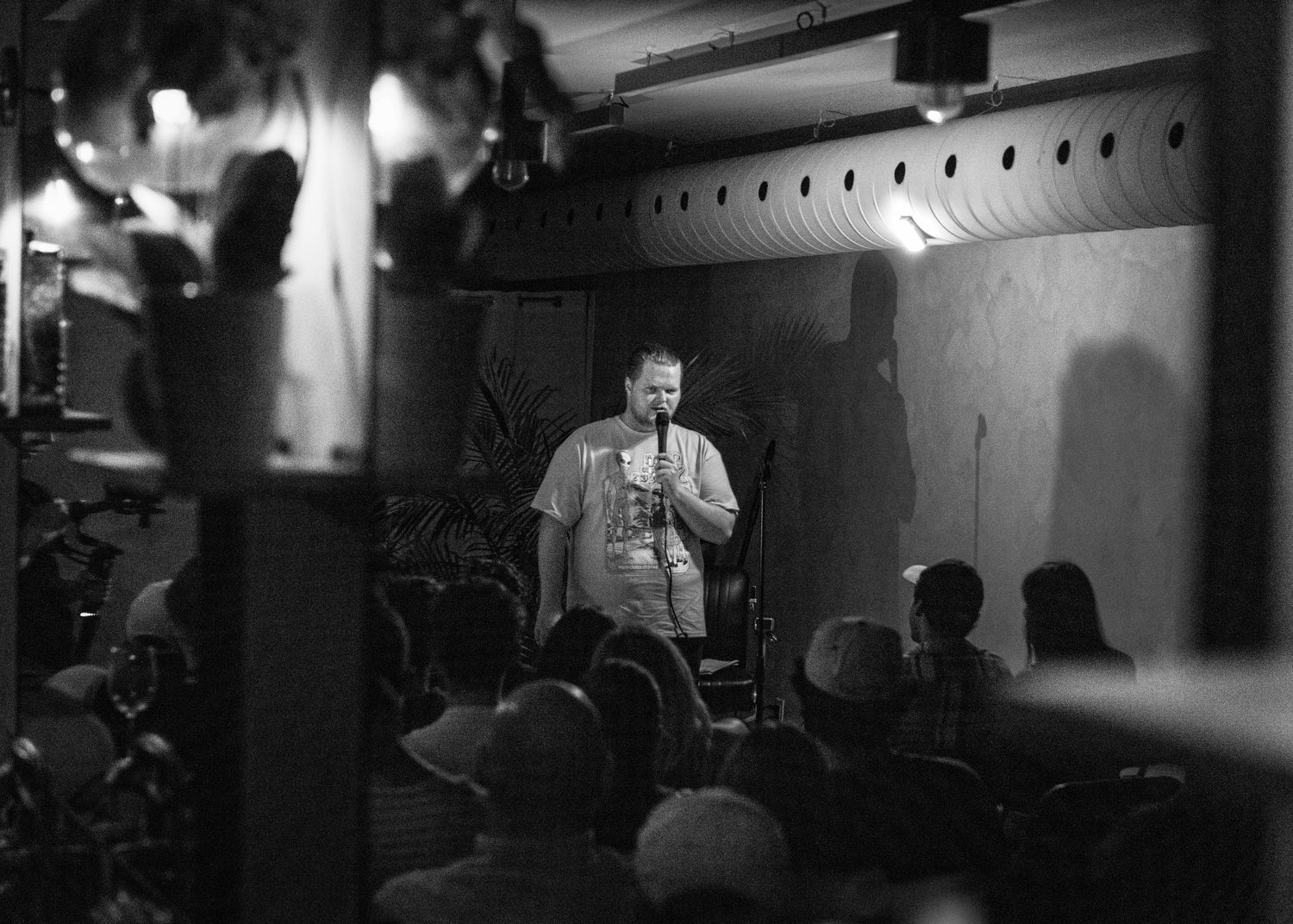 Event photography capturing live moments from the 'Mess Produced' comedy show with performers on stage