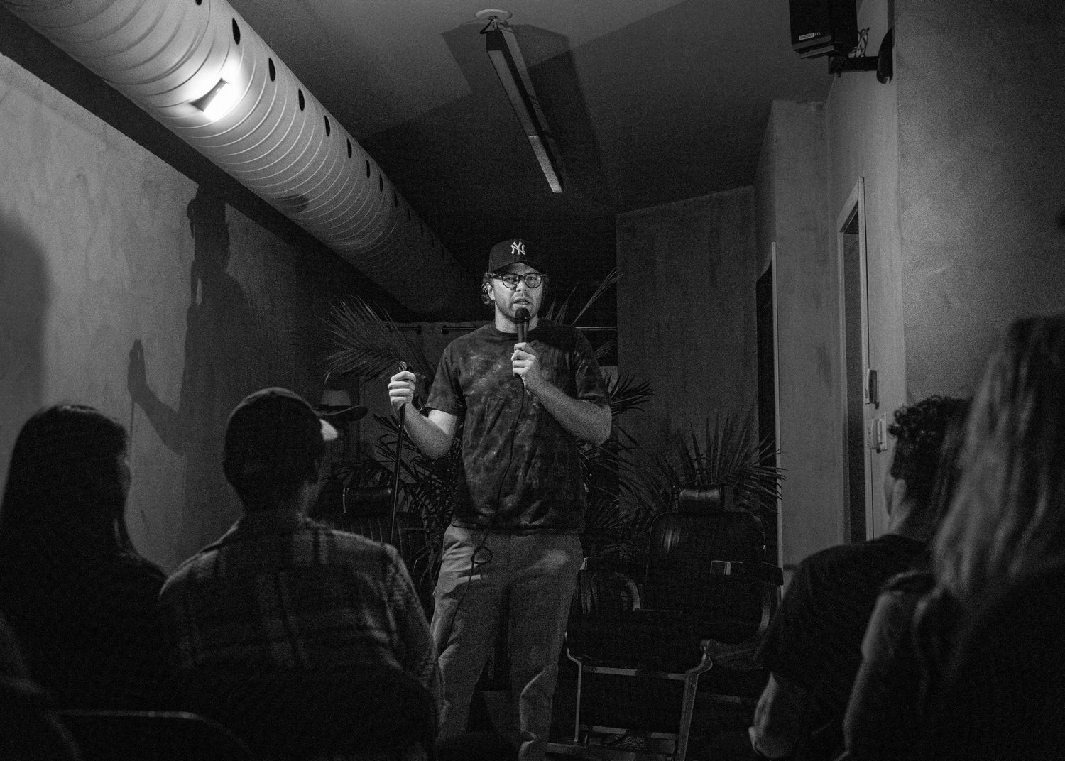 Event photography capturing live moments from the 'Mess Produced' comedy show with performers on stage