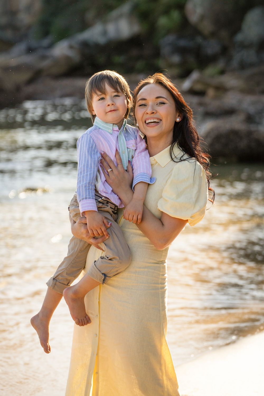 Happy mom and her son cuddling together during a golden hour photoshoot in Sydney's Northern Beaches