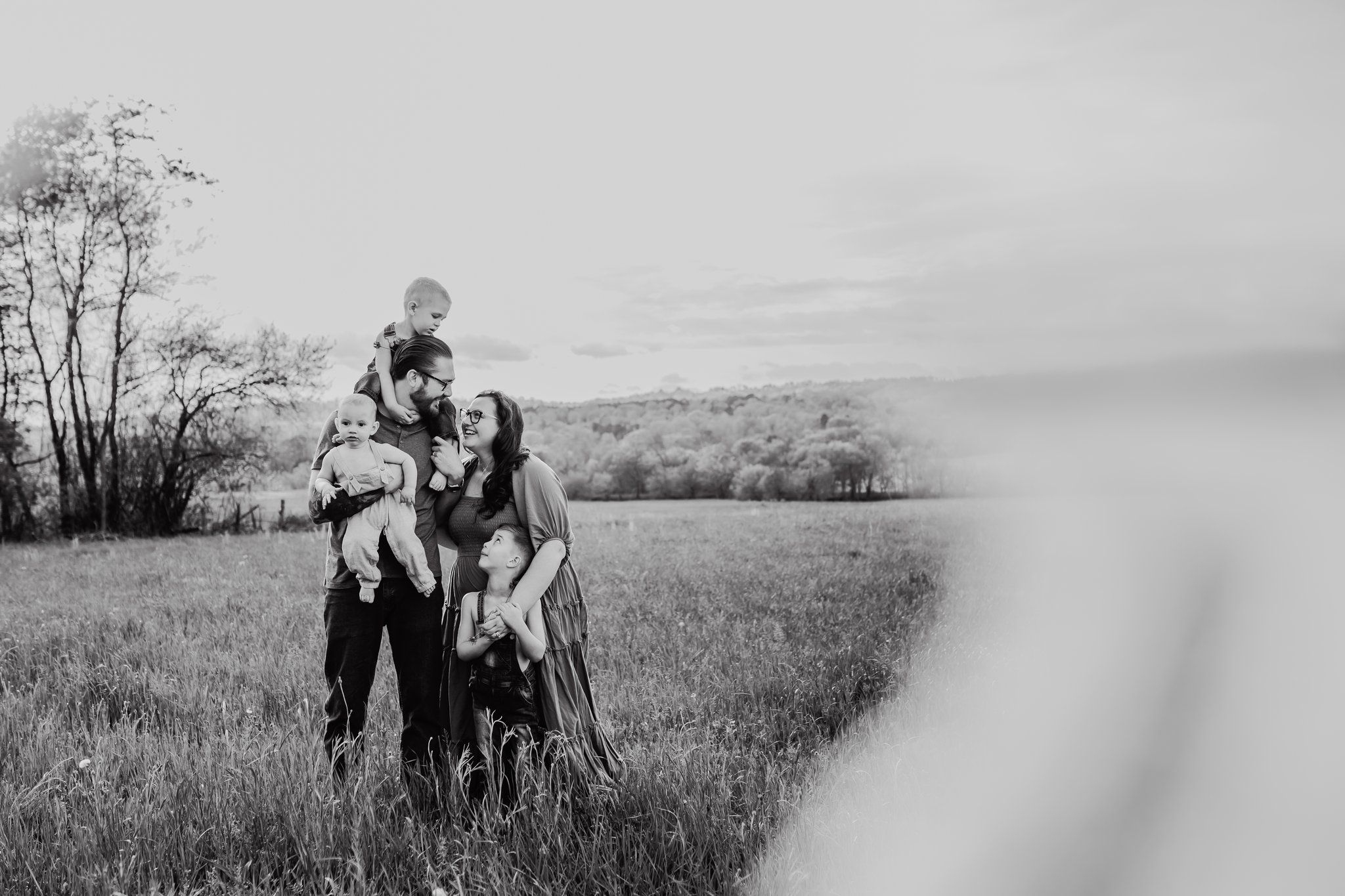 Family stands in a field for family photos knoxville tn