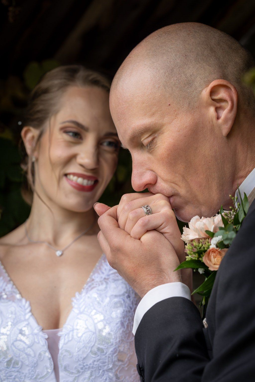 A sequence of intimate wedding photos showing tender moments between a couple with floral decorations.