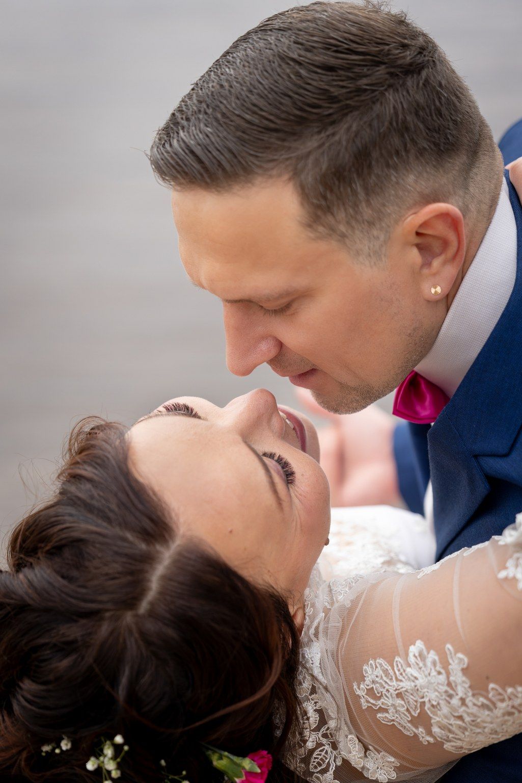 A tender moment between newlyweds in formal wedding attire as they share an intimate close-up.