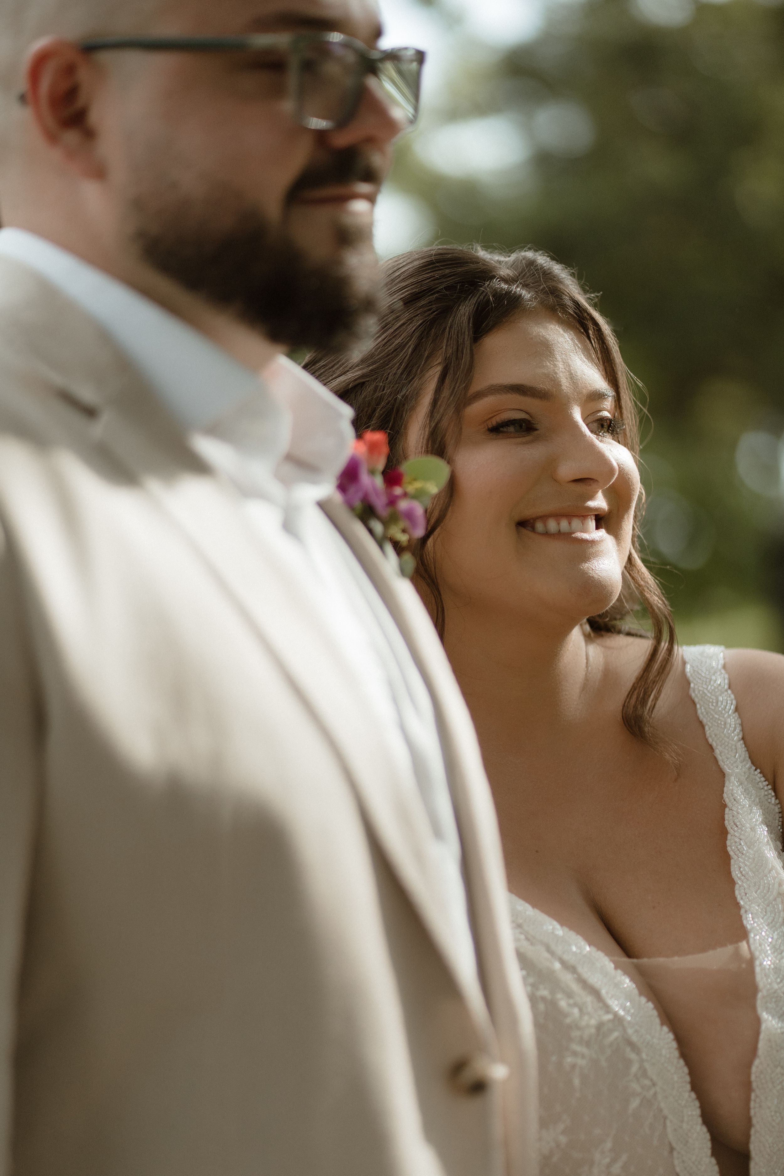 An intimate wedding portrait captured in warm natural lighting with soft bokeh effects.