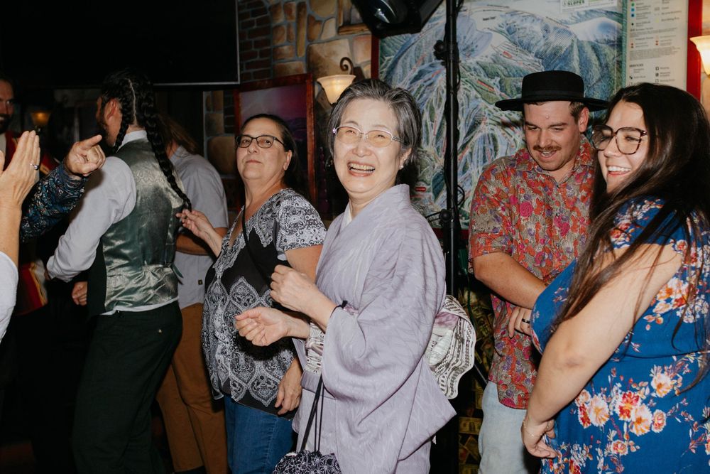 People dancing and socializing at a lively party or celebration event.