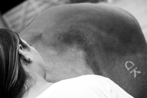 A series of black and white close-up photographs showing various tattoo designs on skin.