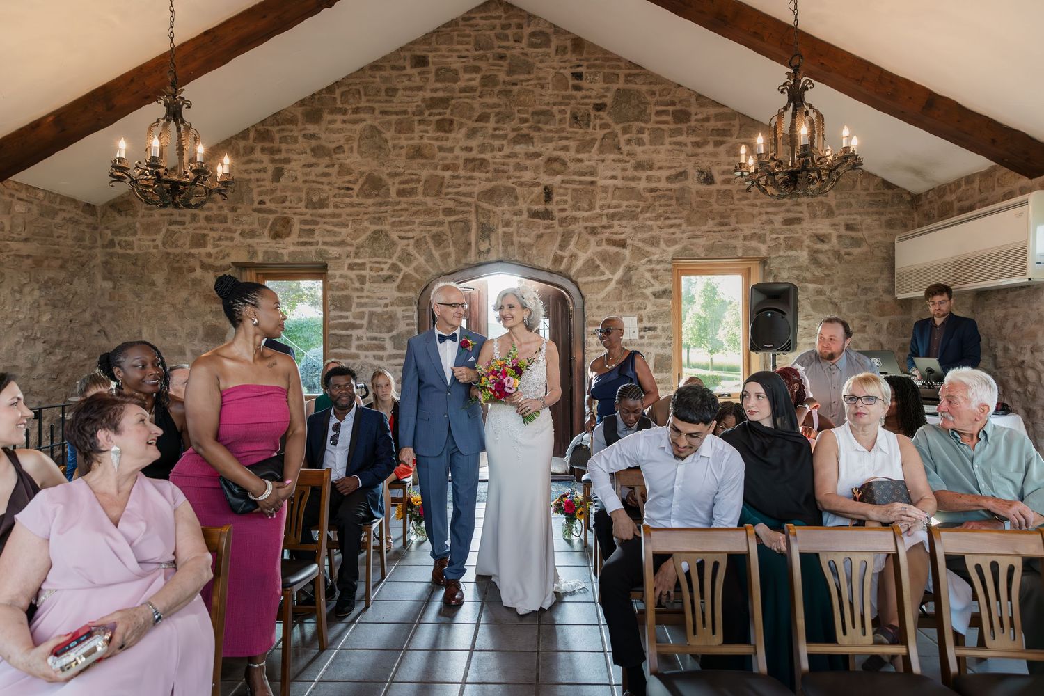 Bride and groom entering together for their wedding ceremony at the Carriage House at Vineland Estates Winery.